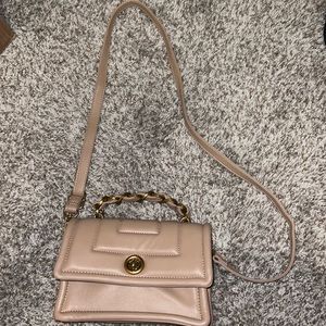 ASOS crossbody purse with gold detail. Padded Crossbody with gold chain detail.